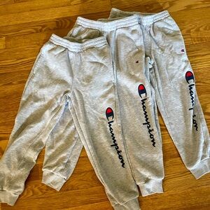 Three pairs of grey Champion kid sweat pants